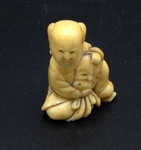 Netsuke of a Boy Holding a Noh Mask of an Old Man