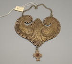 Breast ornament with suspended cross
