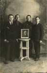 Young Men Standing Behind Framed Photograph in Lodz