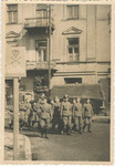 Photograph of German Soldiers Marching Through Piotrkow Trybunalski Ghetto in Poland