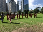 Betania and Karolyna, her friend, walk towards an I love Htown art installation put up for National Heritage Day (2018) by Betania Escobar