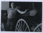 Man Standing Next to a Carriage