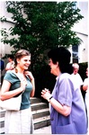 Two women converse outside Church