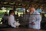 Man and women examine a chicken