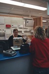 Post office worker gives customer package